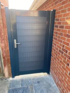 A DuraPost grey gate installed in a residential setting